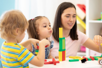 Kids with teacher in kindergarten or daycare