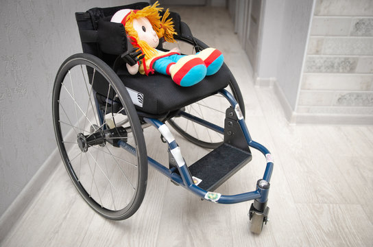 baby wheelchair with doll toy. Disabled children