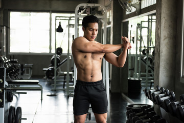 Fototapeta na wymiar Sexy muscle man stretch before exercise