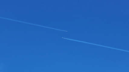 two planes fly towards each other in the sky