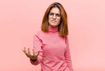 young pretty woman looking angry, annoyed and frustrated screaming wtf or what‚Äôs wrong with...