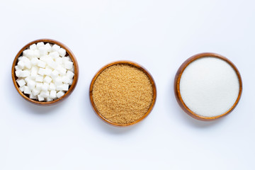 Wooden bowl with sugar on white background.