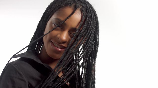 blowing african hair braids cover mixed race model face in slow motion from 60 fps