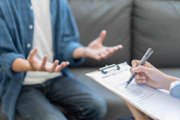 Asian female Doctor and patient are discussing something about medicine ,Having Consultation,Medical physician working in hospital writing a prescription, Healthcare ,medically concept,selective focus