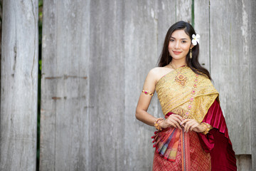 Beautiful woman, Thai national costume, traditional Thai dress, Thai woman, good mood, beautiful smile background - Image with noise and grain