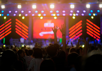 Fototapeta na wymiar Hand ’s crowd at concert - Cheering crowd in front of bright colorful stage lights ,vintage color