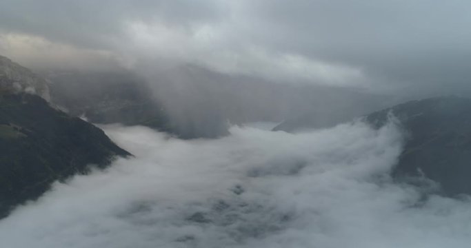 Flying over cloud in swiss montain in autumn