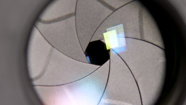 Diaphragm blades of the fixed lens opening and closing aperture f-stop adjustment of a photo camera close-up shot