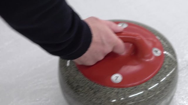 Curler is preparing to start a game. Winter team sport curling. Concept: how to play curling, winter olympic game, indoor games on ice