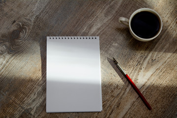 on the table is a notebook, vintage fountain pen and a cup of coffee. Concept - coffee break, business, accountant. Copy space, Top view