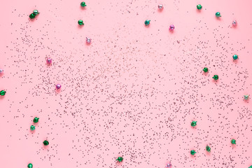 pink and green jingle bells on pink background with glitter - Christmas festive pastel backdrop with copy space