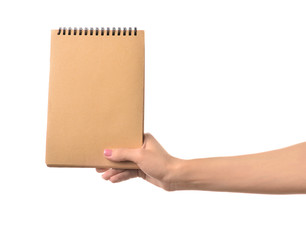 Female hand with notebook on white background