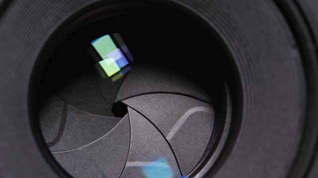 Diaphragm blades of the fixed lens opening and closing aperture f-stop adjustment of a photo camera close-up shot