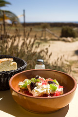 Dakos, greek vegetarian fresh dish  with dried bread and seasonal mediterranean ingredients. Taken in Donoussa Island, Greece
