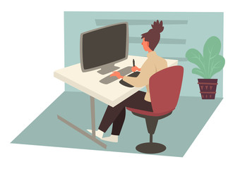 Woman working on computer in office and sitting behind desk