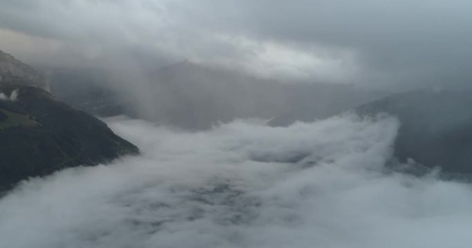 Flying over cloud in swiss montain in autumn