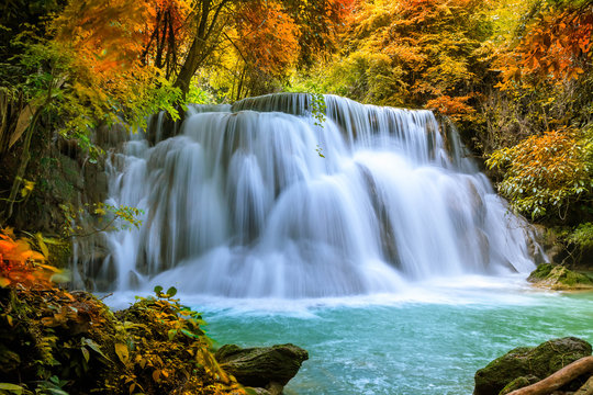 Colorful majestic waterfall in national park forest during autumn - Image