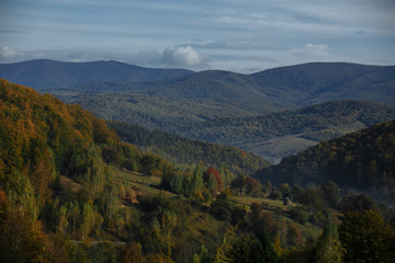 autumn mountains with haze of rising clouds