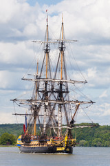 Tall ship Hermione sailing on the Seine River, through green lush countryside, Armada 2019,...
