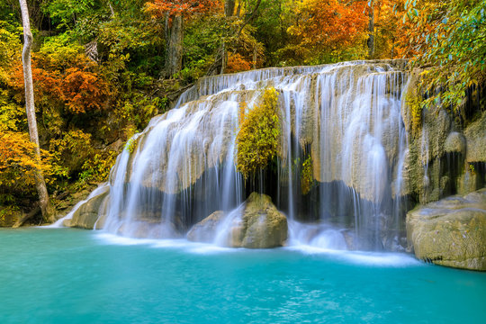 Colorful majestic waterfall in national park forest during autumn © wirojsid