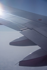 An airplane window view of wing and flaps 