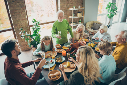 Top above high angle photo of big family sit table celebrate november event thanksgiving day enjoy roast chicken meal retired man stand hold champagne toast small little relatives in house