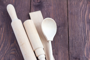 wooden kitchen utensils on rustic wooden background, selective focus