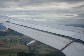 An airplane window view of wing and flaps 