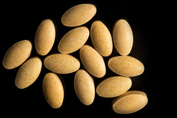 Top view of c vitamin pills on black