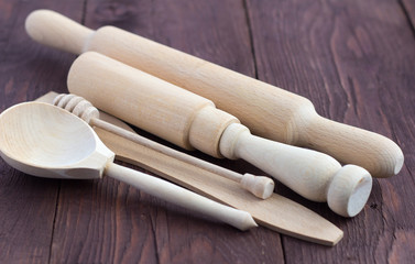 wooden kitchen utensils on rustic wooden background, selective focus