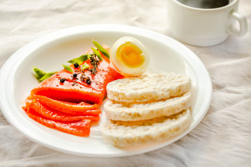 Slices of Salted Raw fish fillet with egg and rice cakes. Selection of good fat sources - healthy eating concept. Ketogenic diet concept. Selective focus