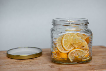 Thinly sliced lemon with sugar in a glass jar