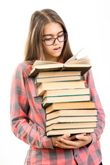 Girl with many books.  student holds a large stack of books. Education. Printed books, study at school. Library. Beginning of studies at the Institute. Young girl with book in glasses