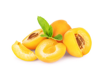 Ripe apricots with mint leaf on white background