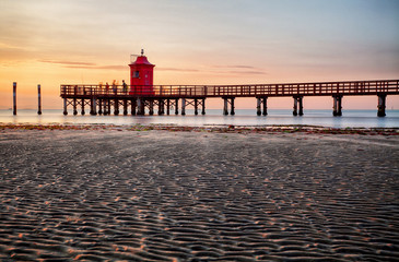 Lighthouse at sunset in Italy with beach