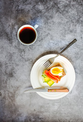 Buckwheat gluten-free bread with avocado and fresh salted salmon fillet with eggs on a gray marble background. Top view. Space for text. High protein and low carb meal
