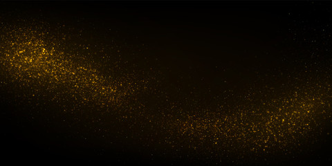 Golden particles, sparkling glitter dust on dark background.