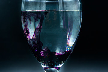 Abstract ink drop to water in glass wine 