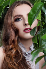Fototapeta premium beautiful girl and green leaves