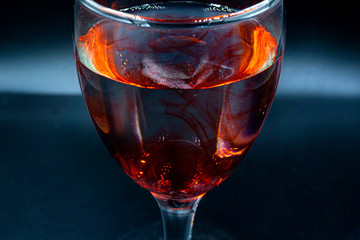 Abstract ink drop to water in glass wine 