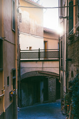 Typical italian narrow street with huge differential in lighting - from bright sun to deep...