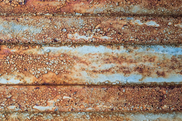 Rusty metal surface with peeling paint. Can be used as backdrop.