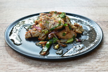  spicy roasted pork Thai salad eat with fresh basil leaf and cabbage on plate