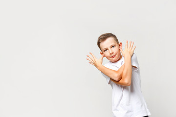 Carefree naughty caucasian boy grimaces. Portrait on an isolated background.
