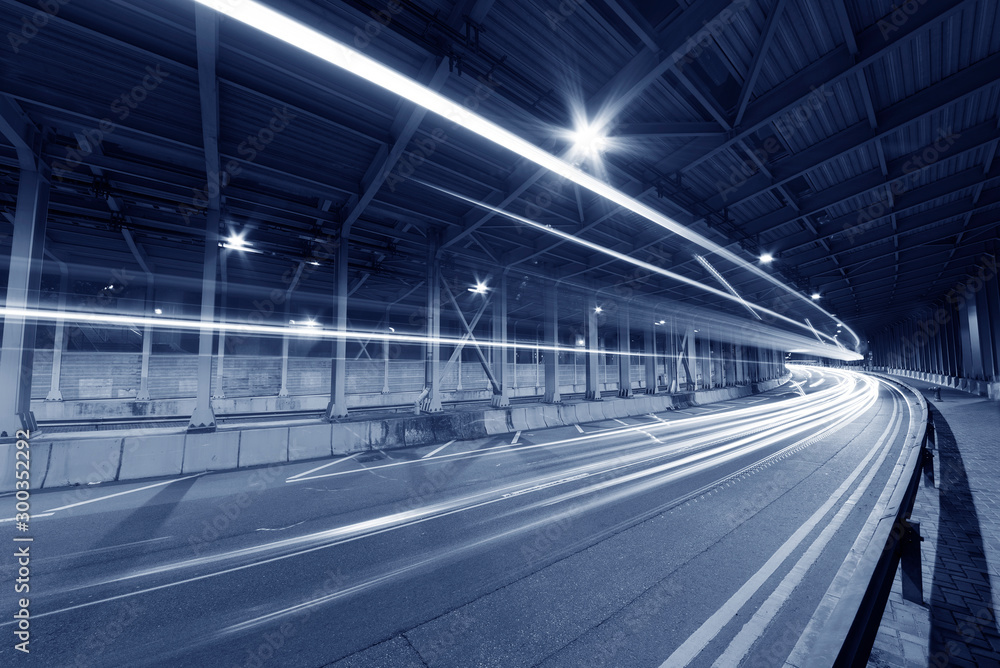 Poster light trails and head lights of traffic in tunnel. transportation background