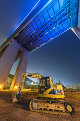 excavator in construction site at night