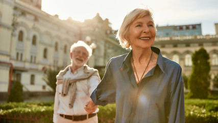 Your love is all I need. Beautiful and happy senior couple holding hands and smiling while spending time together outdoors