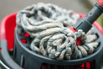 Cleaning mop and red bucket close up  © Angela