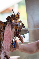 Fototapeta premium ox at the rotisserie in Germany, Dahn, 2019, cutting meat ox