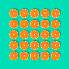 Fruit pattern of fresh mandarin slices isolated on blue or mint background.